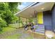 View of the shaded back porch offering outdoor dining space with a grill for relaxing and entertaining at 2536 Bancroft St, Charlotte, NC 28206
