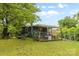 View of backyard, showing the porch, mature trees and grassy area at 2536 Bancroft St, Charlotte, NC 28206