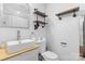 Modern bathroom featuring a stylish sink, industrial shelving, and a mirror at 2536 Bancroft St, Charlotte, NC 28206