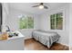 Bright bedroom featuring hardwood floors, a ceiling fan, and natural light at 2536 Bancroft St, Charlotte, NC 28206