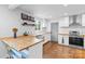 Well-lit kitchen with white cabinets, butcher block counters, and stainless steel appliances at 2536 Bancroft St, Charlotte, NC 28206
