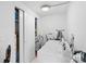 Functional laundry room featuring a washer, dryer and shelving unit for convenient storage at 2536 Bancroft St, Charlotte, NC 28206
