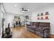 Open living room featuring hardwood floors, a ceiling fan, and ample natural light at 2536 Bancroft St, Charlotte, NC 28206