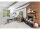 Bright living room featuring a charming brick fireplace and freshly painted white walls and ceilings at 2536 Bancroft St, Charlotte, NC 28206