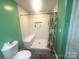 Bathroom with shower, bench seat, and tiled floor at 2601 Marldale St, Gastonia, NC 28052