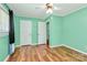 Bedroom features green walls, wood floors, and three white doors at 2601 Marldale St, Gastonia, NC 28052