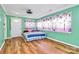 Bedroom features green walls, wood floors, and a bed with floral curtains at 2601 Marldale St, Gastonia, NC 28052