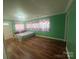 Bedroom with windows, hard wood flooring, and a decorative bed at 2601 Marldale St, Gastonia, NC 28052