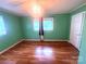 Bedroom with windows, ceiling fan and hard wood flooring at 2601 Marldale St, Gastonia, NC 28052