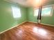 Bedroom with hard wood flooring, windows, and neutral colored paint at 2601 Marldale St, Gastonia, NC 28052