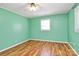 Bedroom features green walls, wood floors, white trim, and a window at 2601 Marldale St, Gastonia, NC 28052
