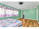 Comfortable bedroom with hardwood floors, large windows, and ensuite bathroom access at 2601 Marldale St, Gastonia, NC 28052