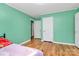Bedroom features green walls, wood floors, and three white doors at 2601 Marldale St, Gastonia, NC 28052