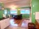 Inviting dining area featuring wood floors, bright green walls, and ample natural light from large windows at 2601 Marldale St, Gastonia, NC 28052
