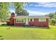 Charming red brick home features a well-manicured lawn and classic design details at 2601 Marldale St, Gastonia, NC 28052
