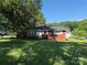 Charming brick home featuring a well-manicured lawn and mature trees, offering a welcoming curb appeal at 2601 Marldale St, Gastonia, NC 28052
