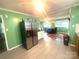 Bright kitchen leading into dining area with tile flooring at 2601 Marldale St, Gastonia, NC 28052
