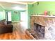 Bright living room with wood flooring and a stone fireplace, flowing seamlessly into the front entry at 2601 Marldale St, Gastonia, NC 28052