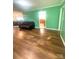 Open-concept living area featuring wood floors, a cozy couch, and seamlessly connects to dining and kitchen spaces at 2601 Marldale St, Gastonia, NC 28052