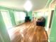 Open-concept living room boasting lots of natural light, wood floors, and a smooth transition into other living spaces at 2601 Marldale St, Gastonia, NC 28052