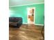 Well-lit living room with wood floors and a partial view of the kitchen, creating a fluid and functional living space at 2601 Marldale St, Gastonia, NC 28052