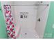 Shower stall with showerhead, built-in niche and bench, and floral shower curtain at 2601 Marldale St, Gastonia, NC 28052