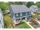Back of the house with fenced yard, manicured lawn, patio, and colorful flowers at 2829 Holt St, Charlotte, NC 28205