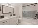 Modern bathroom with sleek vanity, elegant mirror, and glass-enclosed shower at 2829 Holt St, Charlotte, NC 28205