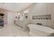 Bright bathroom with modern fixtures, soaking tub, and double vanity sinks at 2829 Holt St, Charlotte, NC 28205