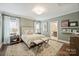 Serene bedroom with soft lighting, cozy rug, and a view into the ensuite bathroom at 2829 Holt St, Charlotte, NC 28205