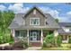 Charming two-story home featuring a welcoming front porch, beautiful landscaping, and an inviting curb appeal at 2829 Holt St, Charlotte, NC 28205