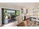 Modern kitchen featuring white cabinetry, quartz countertops, stainless steel appliances, and an adjacent screened porch at 2829 Holt St, Charlotte, NC 28205