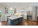 Stunning kitchen with large island, pendant lighting, stainless appliances, and open shelving at 2829 Holt St, Charlotte, NC 28205