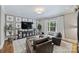 Comfortable living room featuring large windows, plush seating, and stylish decor at 2829 Holt St, Charlotte, NC 28205