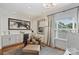 Cozy sitting area with bar, wine cooler, and abundant natural light from the large window at 2829 Holt St, Charlotte, NC 28205