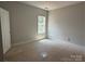 Bedroom featuring neutral paint and trim, and a large window at 2914 Waterford Ln # 33A, Albemarle, NC 28001