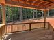Covered wooden patio featuring an expansive view of the lush surrounding woods and a 'For Sale' banner at 2914 Waterford Ln # 33A, Albemarle, NC 28001