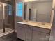 A double sink vanity with a window above, and glass shower next to it at 2915 Noritake Trl # 71, Albemarle, NC 28001