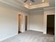 The bedroom has two doors and an open closet, and it is carpeted with trim at the floor at 2915 Noritake Trl # 71, Albemarle, NC 28001