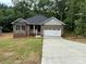 Charming brick home with a well-manicured lawn, attached garage, and inviting front porch at 2915 Noritake Trl # 71, Albemarle, NC 28001
