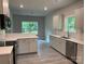 Stylish kitchen with white cabinetry, countertops, stainless steel appliances, and a breakfast bar at 2915 Noritake Trl # 71, Albemarle, NC 28001