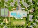 A bird's-eye view of a community pool, tennis court, and basketball court surrounded by trees and parking at 3110 Streamside Dr, Davidson, NC 28036
