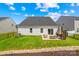 Back exterior of a house showcasing a backyard with lawn and patio at 3110 Streamside Dr, Davidson, NC 28036