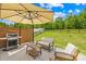 Back patio with BBQ, seating and privacy fence provides a perfect place to relax outdoors at 3110 Streamside Dr, Davidson, NC 28036