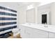 Bright bathroom features dual sinks, white cabinets, and a shower-tub combination at 3110 Streamside Dr, Davidson, NC 28036