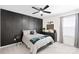 Bedroom featuring dark accent wall, ceiling fan, and closet at 3110 Streamside Dr, Davidson, NC 28036