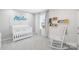 Charming Bedroom with a white crib, rocking chair, and playful decor for a soothing environment at 3110 Streamside Dr, Davidson, NC 28036