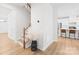 Bright entryway features wood staircase, modern lighting, and seamless flow into the adjacent kitchen at 3110 Streamside Dr, Davidson, NC 28036