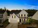 Beautiful two-story home with a two-car garage, manicured lawn and covered entryway at twilight at 3110 Streamside Dr, Davidson, NC 28036