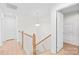 Upstairs hallway with natural light and wood floors provides access to multiple rooms at 3110 Streamside Dr, Davidson, NC 28036